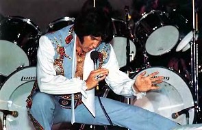 Elvis up close onstage taking Karate stance.
