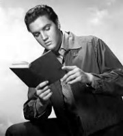 Elvis reading a book.