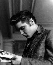 Elvis reading a magazine.