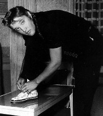 A young Elvis ties his shoe for the camera.