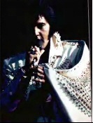 Elvis wearing a spangled suit.