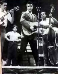 Elvis onstage with his back up band in the 1950s