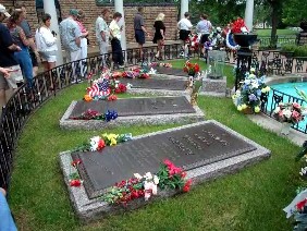 Fans file by Elvis' grave at Graceland.