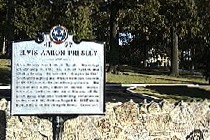 Historical marker sign in front of Graceland wall.