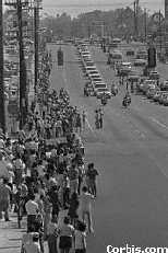 Fans lined up along street as hearse goes by