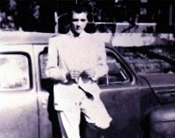 A teenage Elvis stands by his car