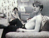 Young Elvis relaxing at home.