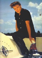 A young Elvis sits on a Lincoln Continental Mark II