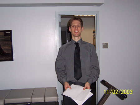 Chris smiles to camera.