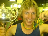 Jack Dixon holds his Australasian best & fairest trophy and All-star medal upon his return to Brisbane
