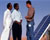 Photo of business man talking to locals in India with solar panel in the background