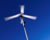 Photo of wind turbine against a blue sky