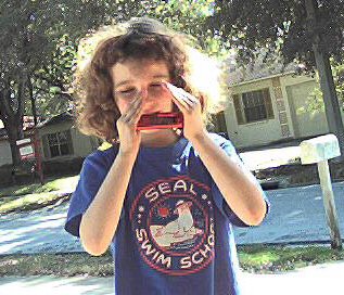 Kathryn playing harmonica; photo credit, Vincent Lew Griffith