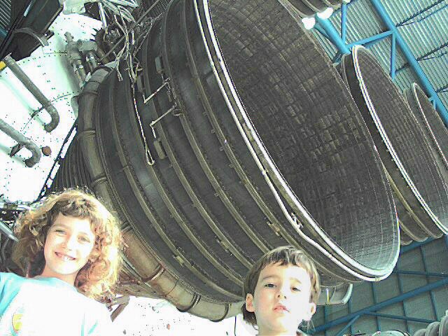Vincent and Kathryn underneath Saturn V engines at Kennedy Space Center