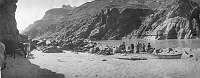 CANVAS BOAT USED TO RESCUE. FLAT  BOTTOMED BOAT USED TO FERRY EQUIPMENT. PHOTO FROM SAND BAR ON THE NORTH SIDE OF THE COLORADO RIVER AT BASS CROSSING. LEFT TO RIGHT: JOHN WALTENBERG, JIM HUDSON (WILLIAMS), BENTLY SR., DR. P.A. MELLICK (WILLIAMS), CHAS NEA
