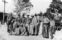 11 WRANGLERS POSE NEAR BRIGHT ANGEL CAMP OFFICE. &quotNORTHERN ARIZONA ROUNDUP CREW.&quot NOV 1919. RYAN.