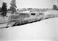 SIDE VIEW OF LOCOMOTIVE: SANTA FE TRAIN &quotEL CAPITAN&quot IN STATION AT GRAND CANYON DURING FIRST LOS ANGELES TO CHICAGO RUN. SNOW. 19 FEB 1938