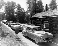 LINE OF CARS BACKED UP & WAITING TO PAY ENTRANCE FEE AT SOUTH ENTRANCE STATION. AUG 1951. NPS PHOTO BY EDEN