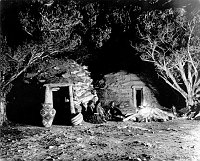 POSED &quotINDIAN CAMPFIRE&quot IN FRONT OF FRED HARVEY NAVAJO EMPLOYEE HOGANS ADJACENT TO HOPI HOUSE. 14 NOV 1906. PUTNAM & VALENTINE. 