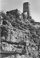 DESERT VIEW WATCHTOWER SEEN FROM BELOW RIM. KAIBAB ROCK CLIFF FACE PROMINENT. CIRCA 1933. FRED HARVER CO. 