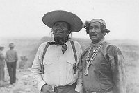 PORTRAIT: 2 HOPI MEN STANDING BY DESERT VIEW POINT DURING WATCHTOWER DEDICATION. 13 MAY 1933. FRED HARVEY CO. 