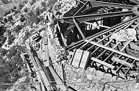 WATCHTOWER CONSTRUCTION SITE. VIEW DOWN ONTO OPEN ROOF OF KIVA BUILDING. WORKMAN WALKING WALL. SCAFOLDING BELOW. CIRCA 1931. COLTER