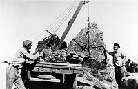 MEN POSING BY WINCH USED TO PUT ROCKS IN PLACE DURING WATCHTOWER CONSTRUCTION. CIRCA 1932, HIRCHBORN