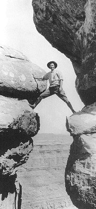 GRCA 22689  Emery Kolb on rocks above Stillwater Canyon, 1911