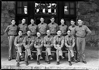 14 BELL BOYS POSE OUTSIDE MAIN ENTRANCE TO THE GRAND CANYON LODGE, NORTH RIM. 20 JULY 1930. NPS PHOTO