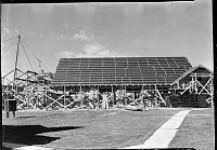 RECONSTRUCTION OF GRAND CANYON LODGE ON THE NORTH RIM BY RYBERG BROTHERS OF SALT LAKE CITY. SECTION OF ROOF TAR PAPERED &. READY FOR SHINGLES. FIREPROOF STEEL FRAMING VISIBLE ON LEFT. 12 OCT 1936 NPS PHOTO<br>