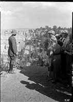 NATURALIST MCHENRY SHOWS AN AUTO CARAVAN GROUP THE ANGELS WINDOW AT CAPE ROYAL, NORTH RIM. CIRCA 1933 NPS PHOTO.
