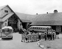 THE FAMOUS EMPLOYEE &quotSING-AWAY&quot CEREMONY AS VISITORS LEAVE THE GRAND CANYON LODGE, ON THE NORTH  RIM. TWO TOUR BUSSES. 23 JUNE 1949 NPS PHOTO BY EDEN