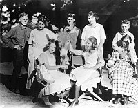 WYLIE WAY CAMP STAFF WITH THE MCKEE FAMILY AND BRIGHTY THE BURRO. CABIN BEHIND. FIRST NORTH RIM TOURIST CAMP. JULY 1918. PUB.