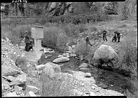 PHANTOM RANCH: UPPER CROSSING OF BRIGHT ANGEL CREEK: CCC CREW SURVEYING  FOOTBRIDGE SITE. CIRCA 1936 NPS PHOTO. 