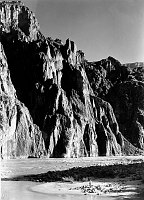NATURALIST, EDWIN D MCKEE STANDS ON COLORADO RIVER BEACH BELOW KAIBAB BRIDGE. CIRCA 1930. NPS PHOTO BY GRANT.