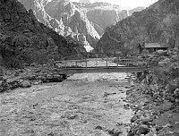 BRIGHT ANGEL CREEK FLASHING AS IT RUSHES UNDER CAMPGROUND BRIDGE. DAMAGE TO BANK. 12 DEC 1966. SCHAACK, NPS. 