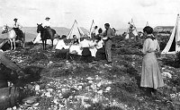 &quotCAMPING ON THE RIM&quot 6 TENTS, 2 HORSES, GROUP EATING AT TABLE. MAN CHOPPING WOOD. CIRCA 1910. MOON, KARL.