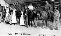 &quotFRED HARVEY BUNCH&quot GROUP OF 13 EMPLOYEES STANDING BY THE BRIGHT ANGEL HOTEL. 5 HARVEY GIRLS. 4 HORSES. CIRCA 1915. BROWN.