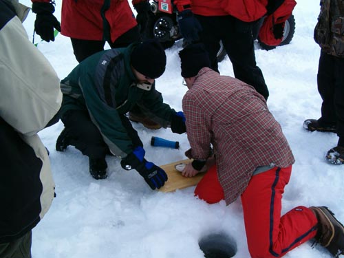 Tom measures his second lake trout...