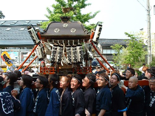 This is a mikoshi, or portable shrine. It looks hard work but as a rule everyone's too drunk to notice.