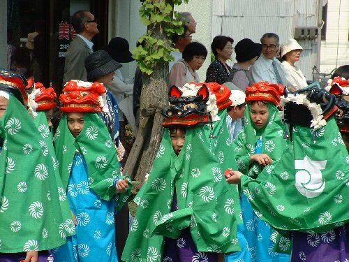 Local primary school children dressed as lions at Sakata festival.