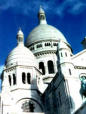 Some white church thingy on a hilly majiggy...