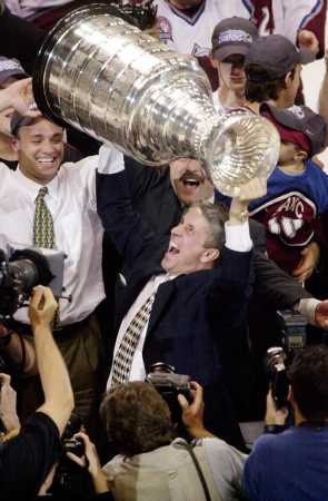 Hartley hoists the Cup.