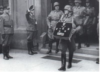 Rommel's baton, medals and decorations being carried from the Rathaus