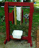 This photo is of my honey presswhich was made using a scissor-type automobile jack to apply pressure to two vertical plates.  The honey bag is squeezed between the vertical plates.