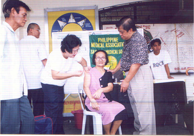 Dr. Mela administering vaccine