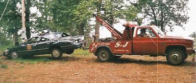A giant oak tree felt that this police cruiser was a softer landing pad in a storm...the only vehicle parked in the yard