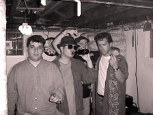 One of these guys ain't in the band.    No 10 Pounder gives the metal horns that weakly!