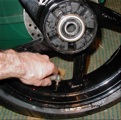 Push the tire into the drop center and pry opposite