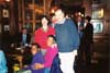 Standing: members Nadir and Nigel (SOS). Seated: non member Lidiane, and member Val. In background: other members.